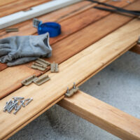 Outdoor Wooden Terrace with Work Tools Wooden terrace with work tool on an outdoor deck in the process of being build and renovated.